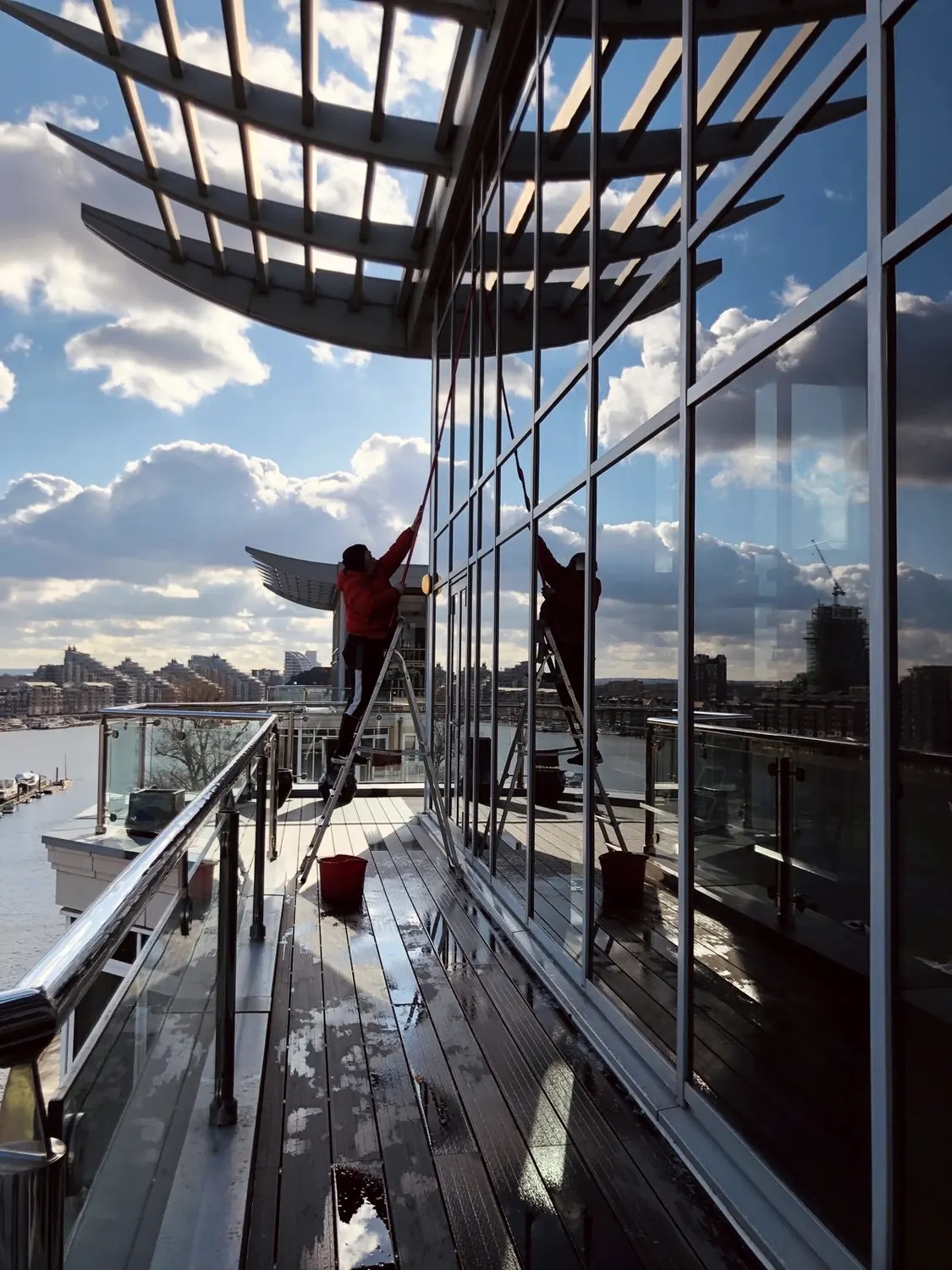 Exterior window cleaning on a riverside London balcony